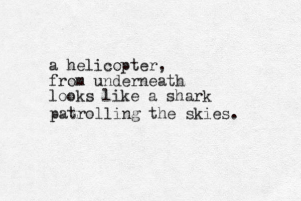 a helicopter, from underneath looks like a shark patrolling the skies. 