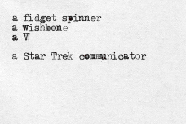 a fidget spinner a wishbone a V a Star Trek communicator 