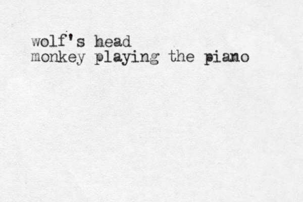 wolf's head monkey playing the piano 