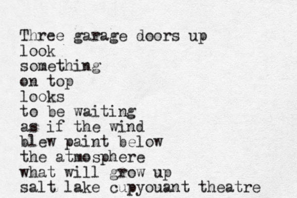 Three garage doors up look something on top looks to be waiting as if the wind blew paint below the atmosphere what will grow up salt lake cupyouant theatre 