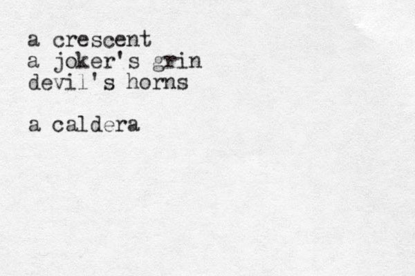 a crescent a joker's grin devil's horns a caldera